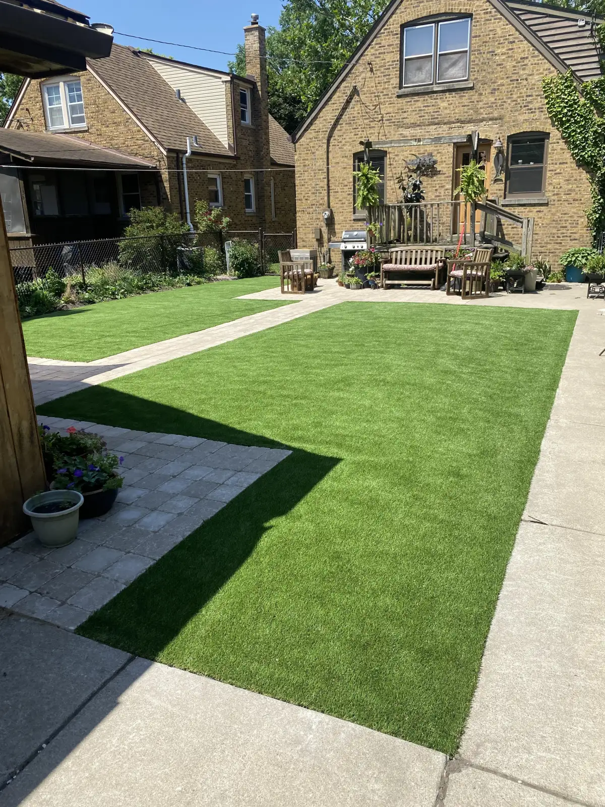 Finished synthetic turf lawn with clean edge system